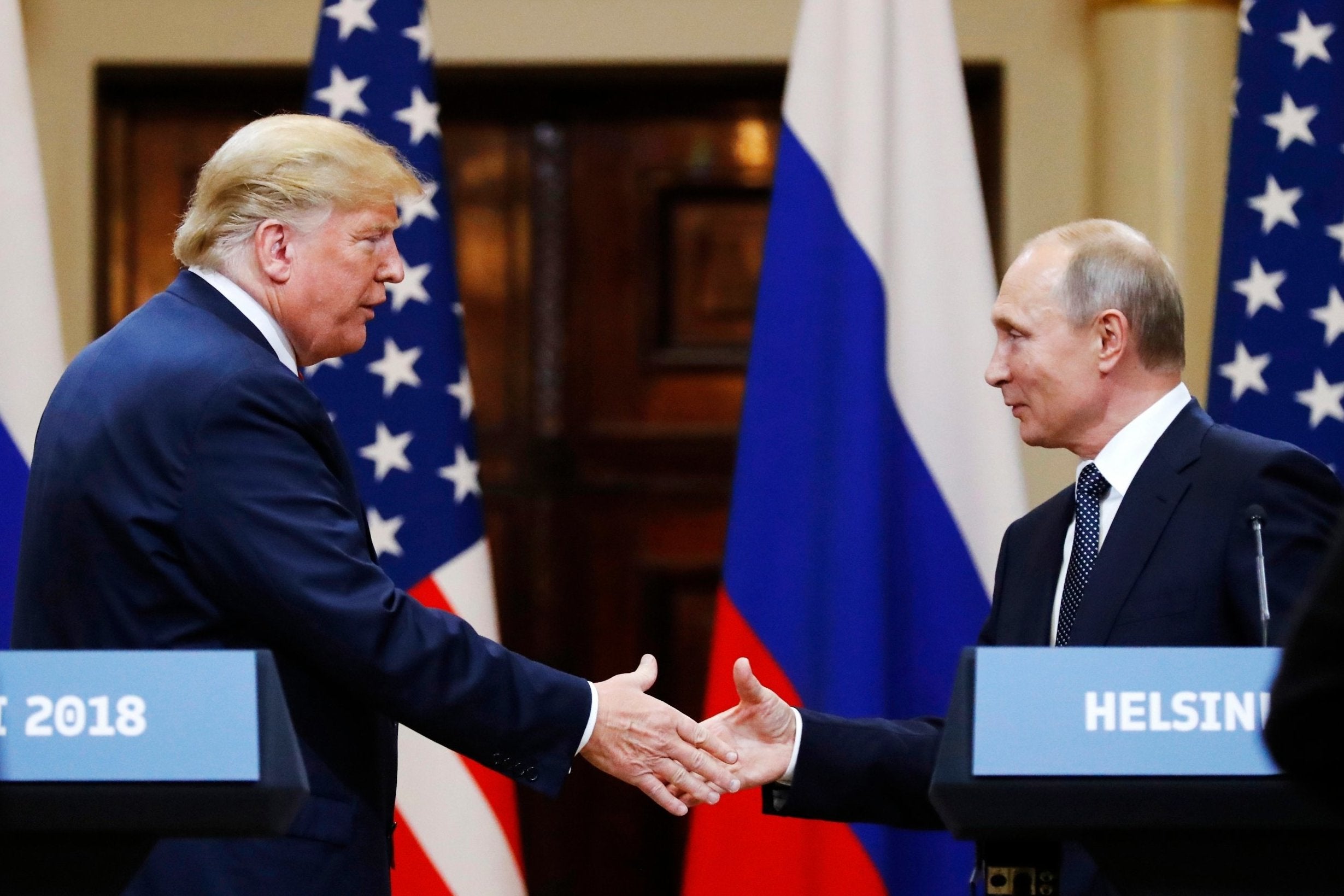 Pictured: President Donald Trump shakes hand with Russian President Vladimir Putin after their meeting at the Presidential Palace, Helsinki, Finland, 16 July 2018.