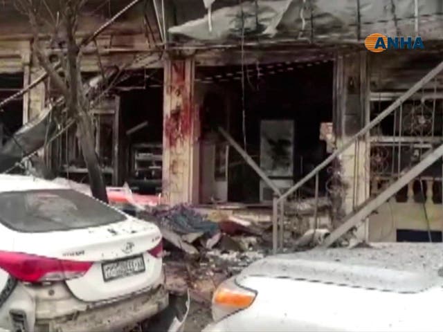 A grab from video provided by Hawar News, ANHA, the news agency for the semi-autonomous Kurdish areas in Syria, shows a damaged restaurant where an explosion occurred, in Manbij, Syria