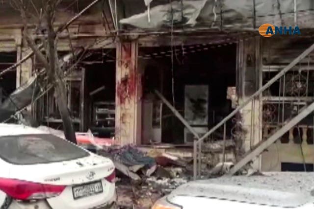 A grab from video provided by Hawar News, ANHA, the news agency for the semi-autonomous Kurdish areas in Syria, shows a damaged restaurant where an explosion occurred, in Manbij, Syria