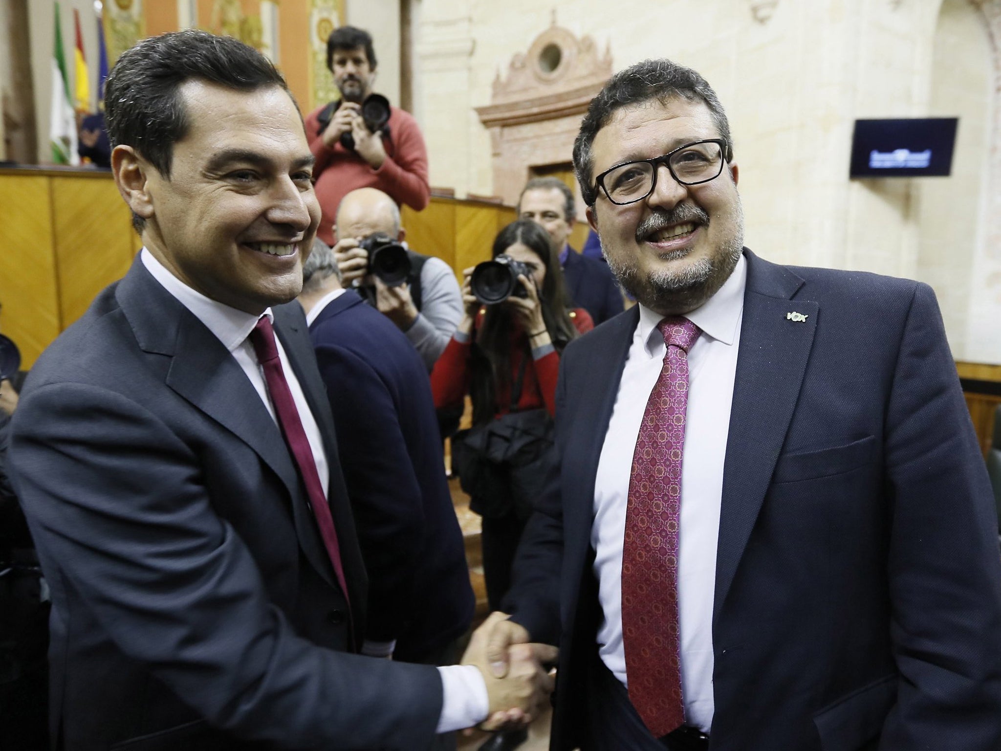 New Andalucian regional president Juanma Moreno (left) is congratulated by far-right party Vox’s spokesperson Francisco Serrano at Andalusian parliament in Seville