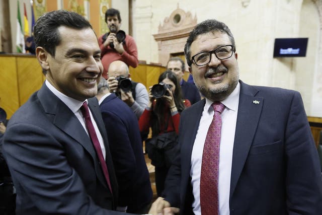 New Andalucian regional president Juanma Moreno (left) is congratulated by far-right party Vox’s spokesperson Francisco Serrano at Andalusian parliament in Seville