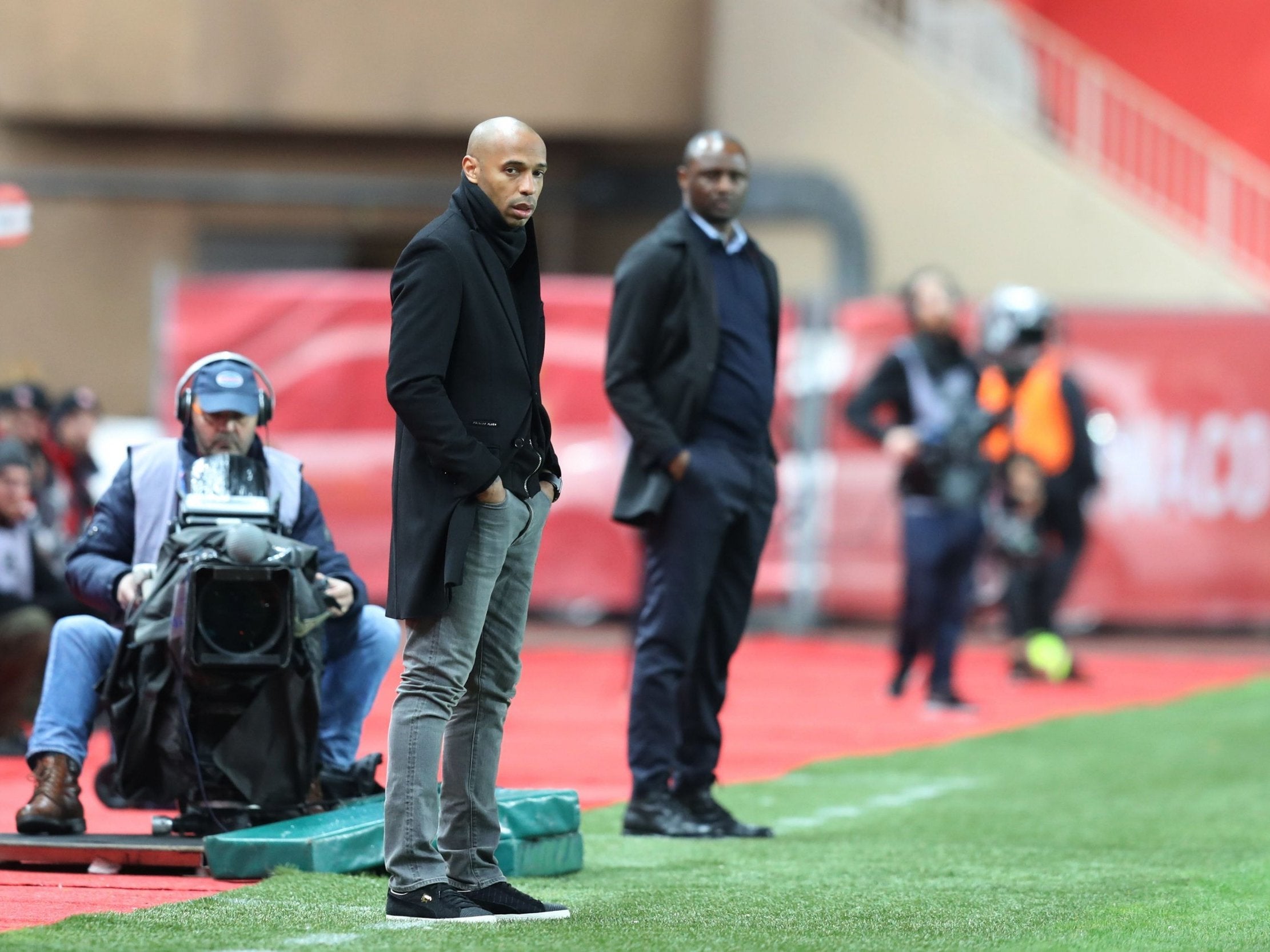 Thierry Henry and Patrick Vieira watch on from the touchline