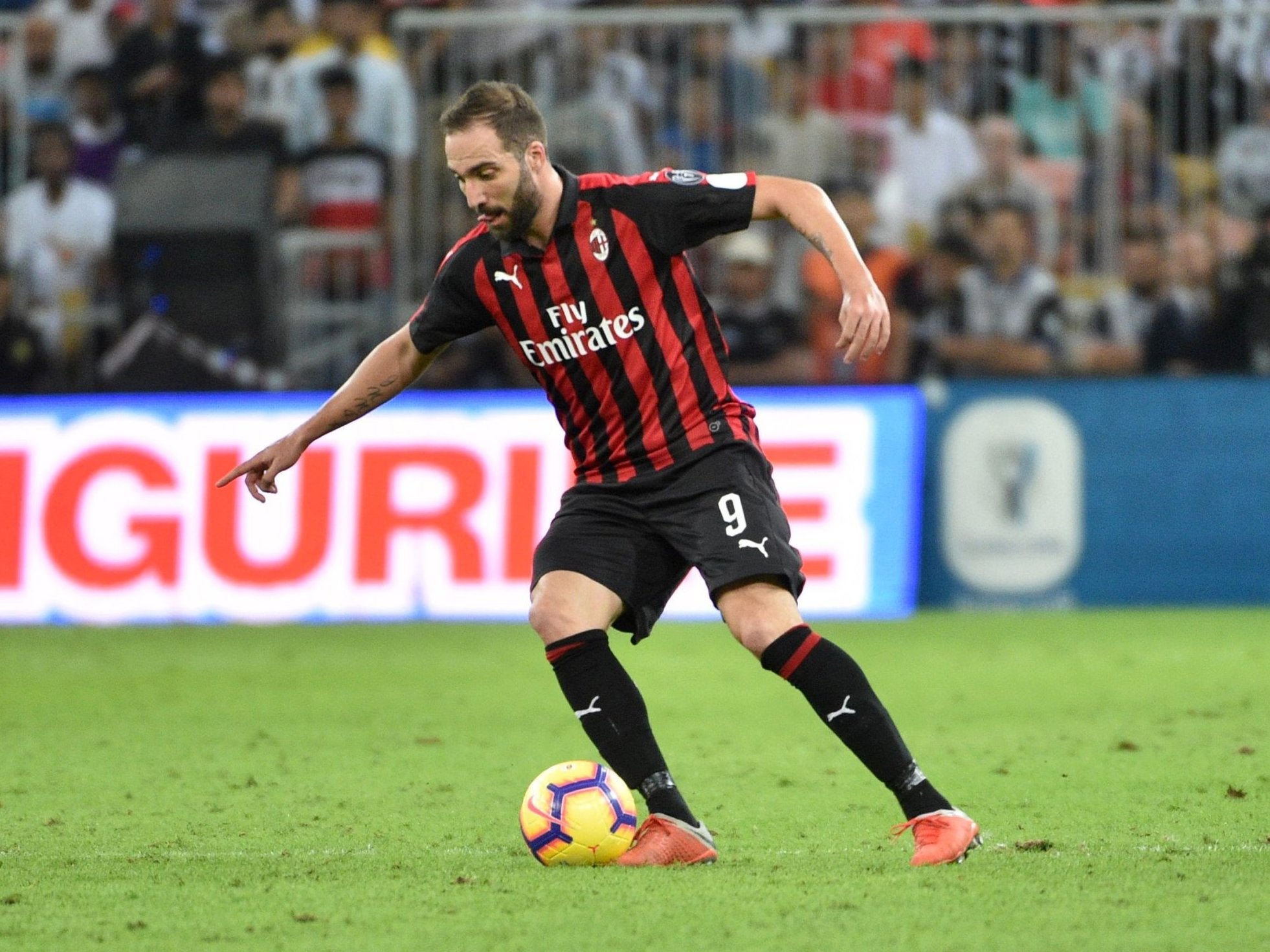 AC Milan’s Gonzalo Higuain controls the ball