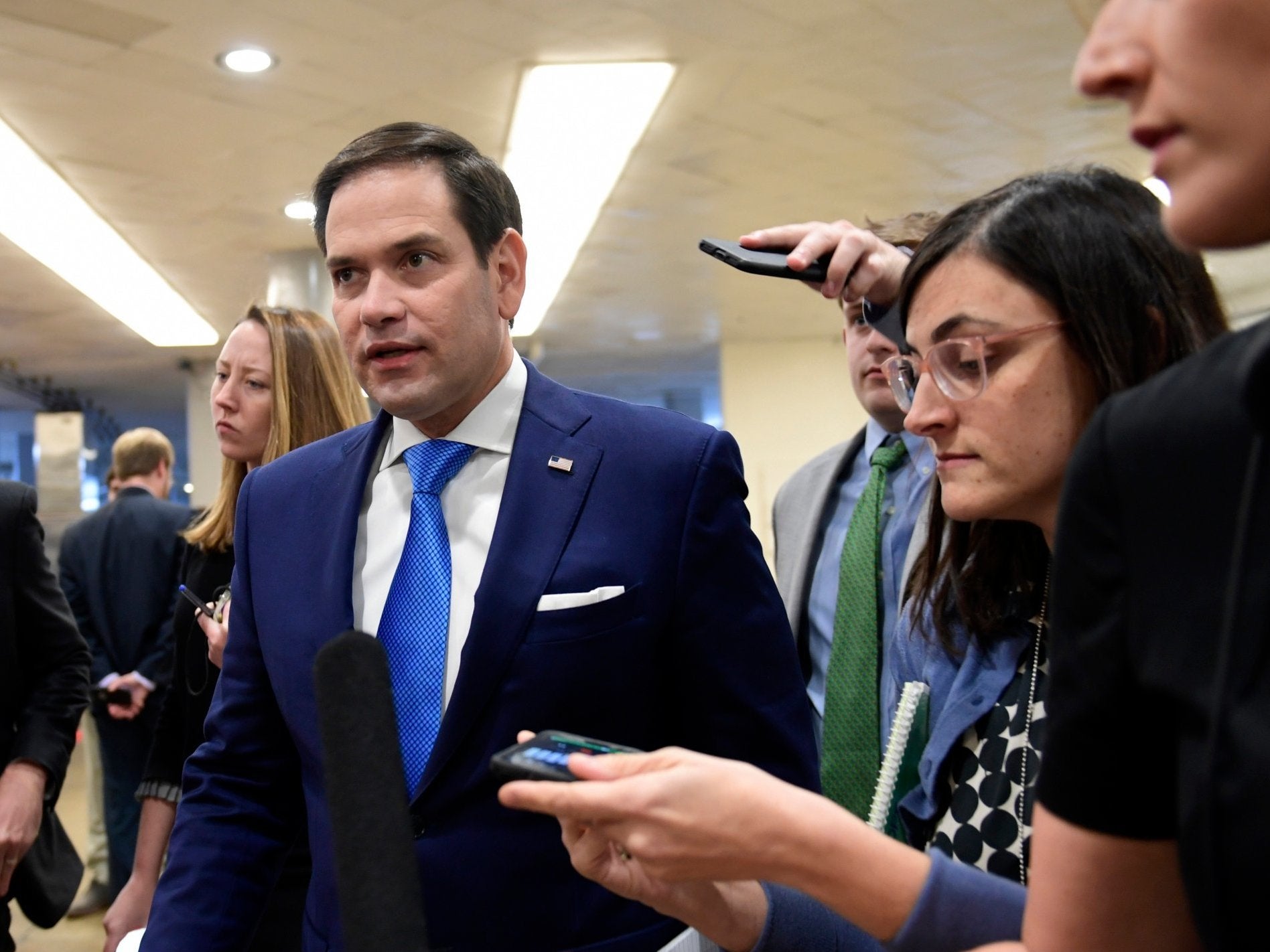 Senator Marco Rubio, R-Fla, center, is followed by reporters on Capitol Hill
