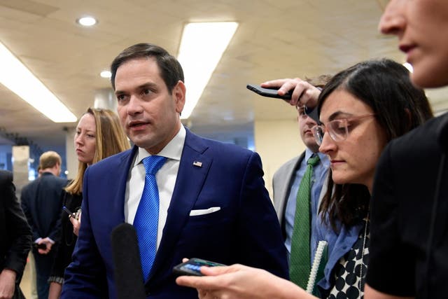 Senator Marco Rubio, R-Fla, center, is followed by reporters on Capitol Hill