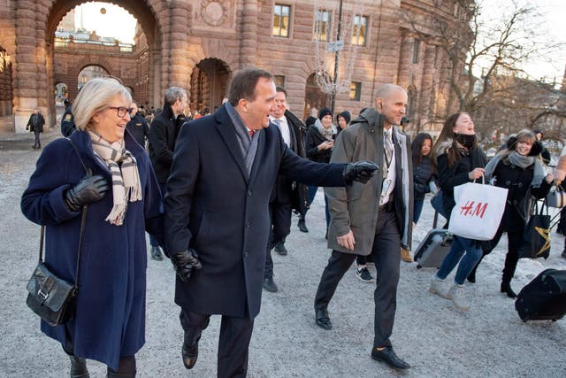 Sweden's Prime Minister Stefan Lofven (C) leaves the Swedish Parliament Riksdagen together with his wife Ulla (L) after after being voted back in as prime minister
