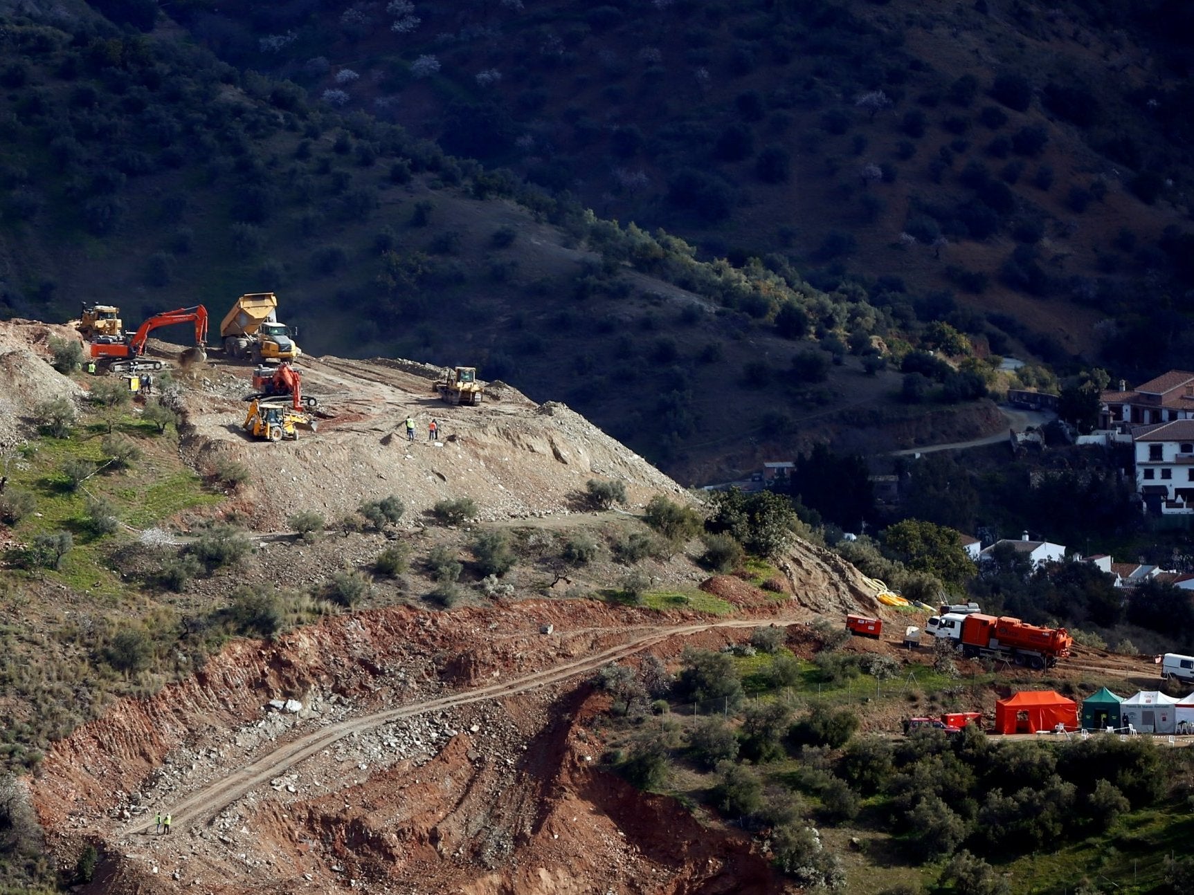 Diggers and trucks remove sand at the area where Julen, a Spanish two-year-old boy fell into a deep well