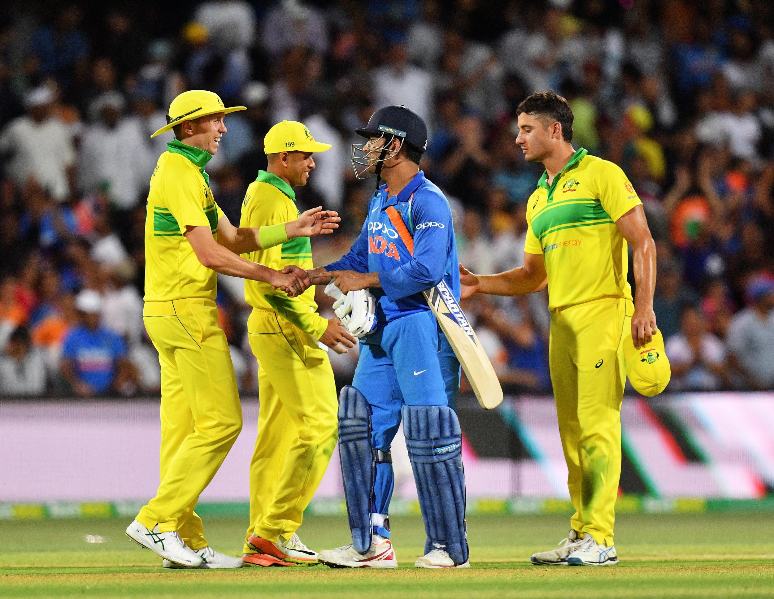 A vanquished Peter Siddle shakes hands with Dhoni as India defeat Australia