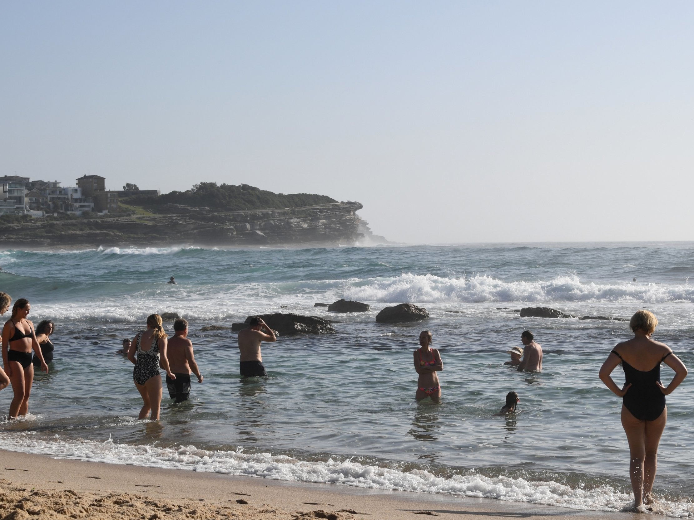 Beachgoers cool off at Bronte Beach in Sydney, New South Wales, amid an intense heatwave