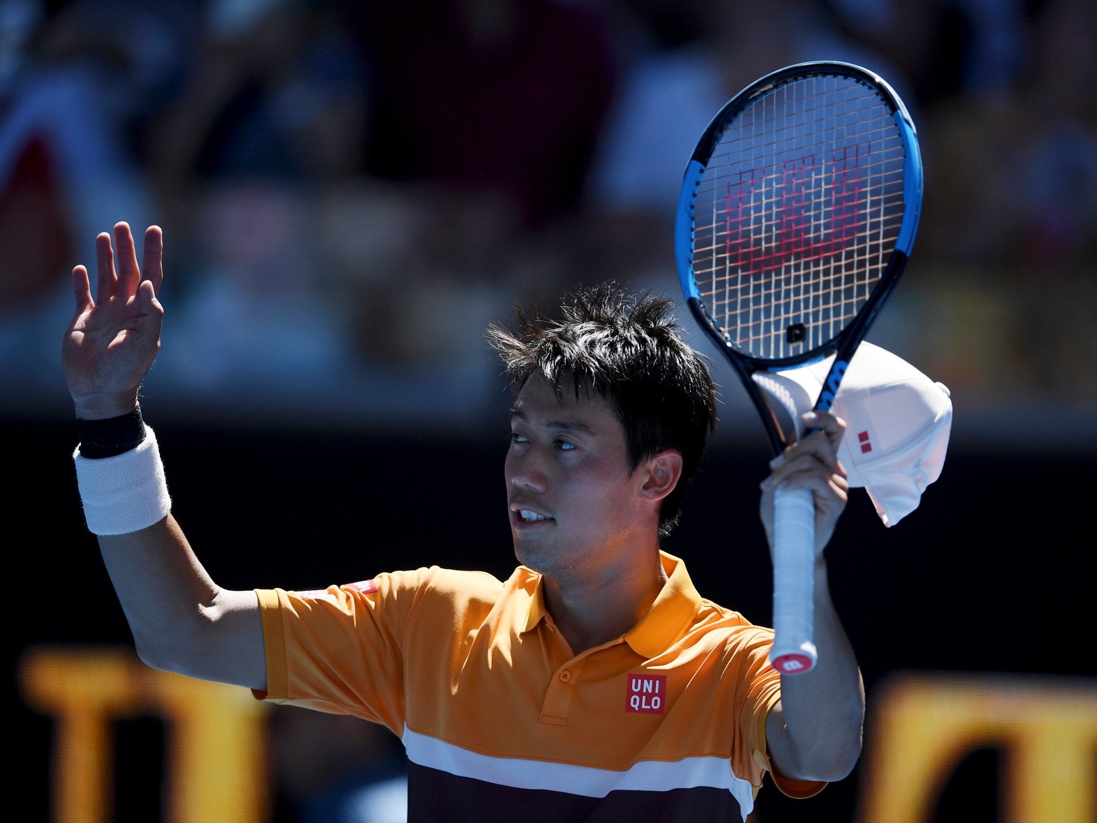 Kei Nishikori salutes the crowd after defeating Joao Sousa in the third round