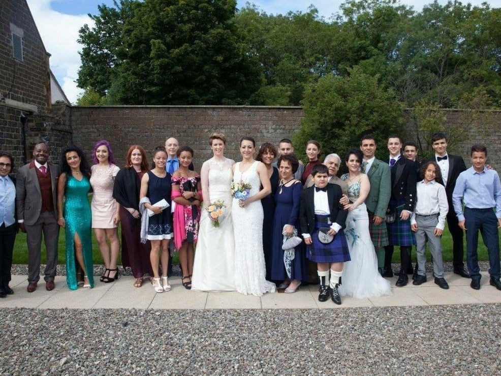 The couple (7th and 8th from right) at a family wedding