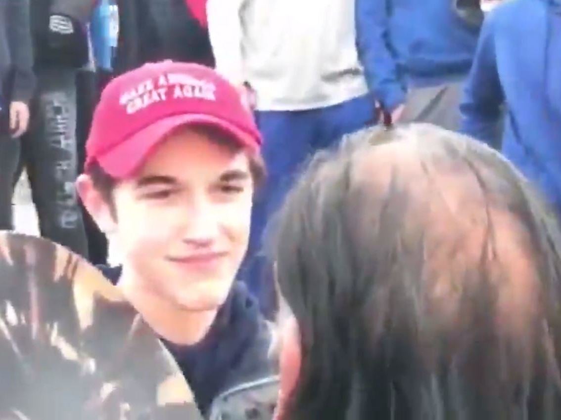 A crowd formed around Nathan Phillips as he drummed and sang following an indigenous peoples' march