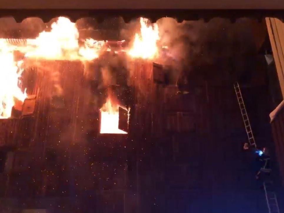 Footage posted on social media showed firefighters using ladders to rescue trapped workers