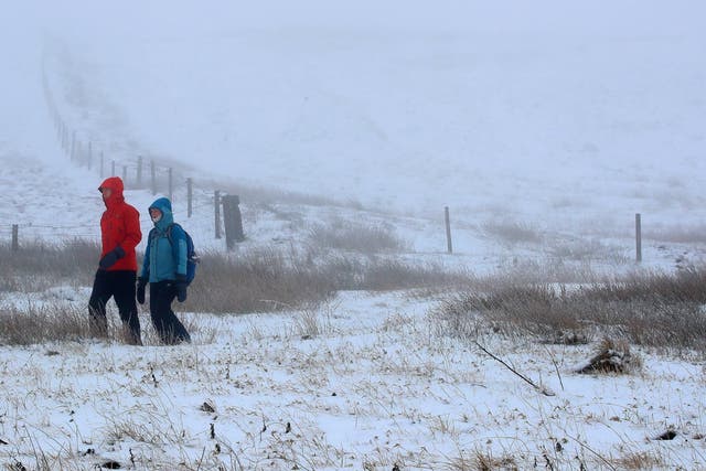 Walkers on a snow-covered path outside the Peak View tea rooms near Macclesfield, Cheshire.