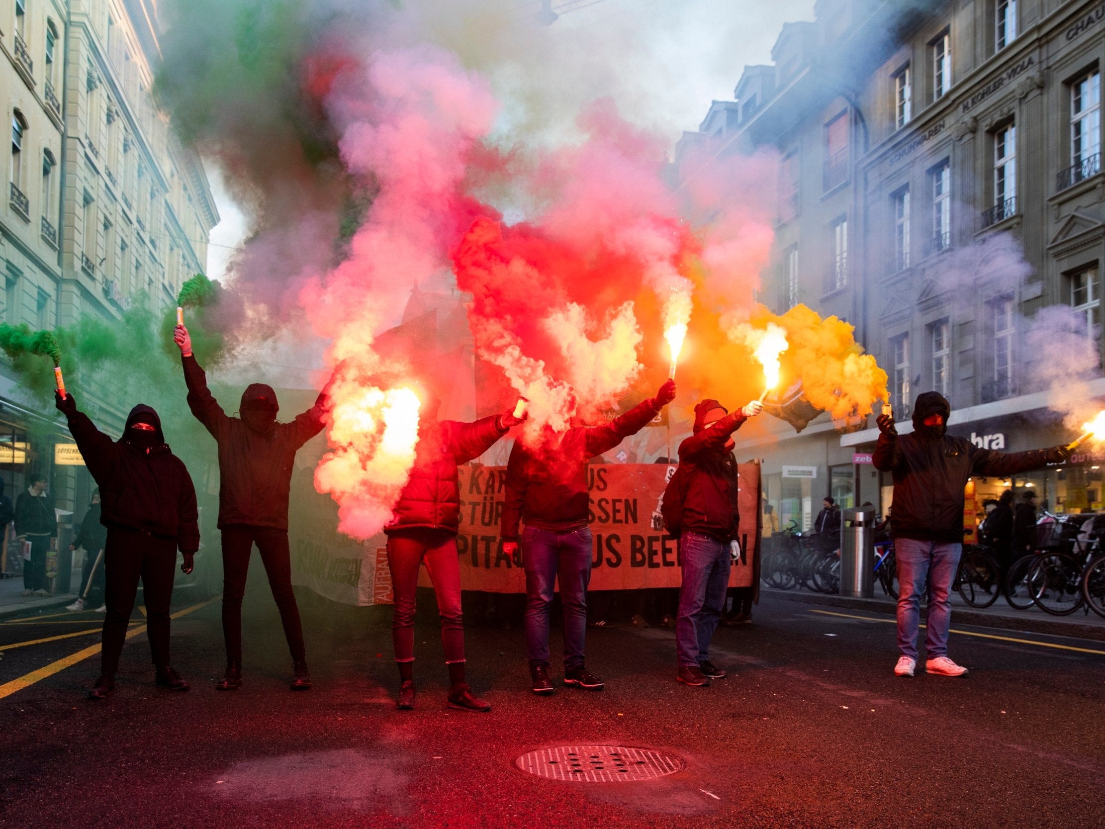 Protesters burn fireworks during a demonstration against the World Economic Forum on Saturday