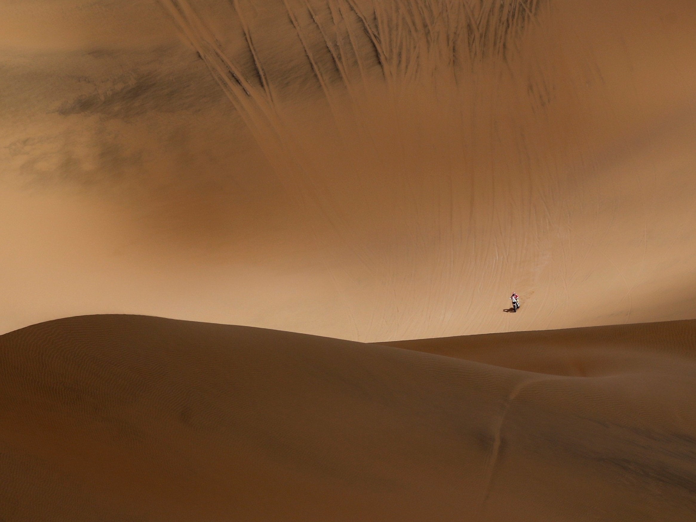 A rider crosses sand dunes during Stage 5, from Tacna to Arequipa, of the Dakar Rally in Peru