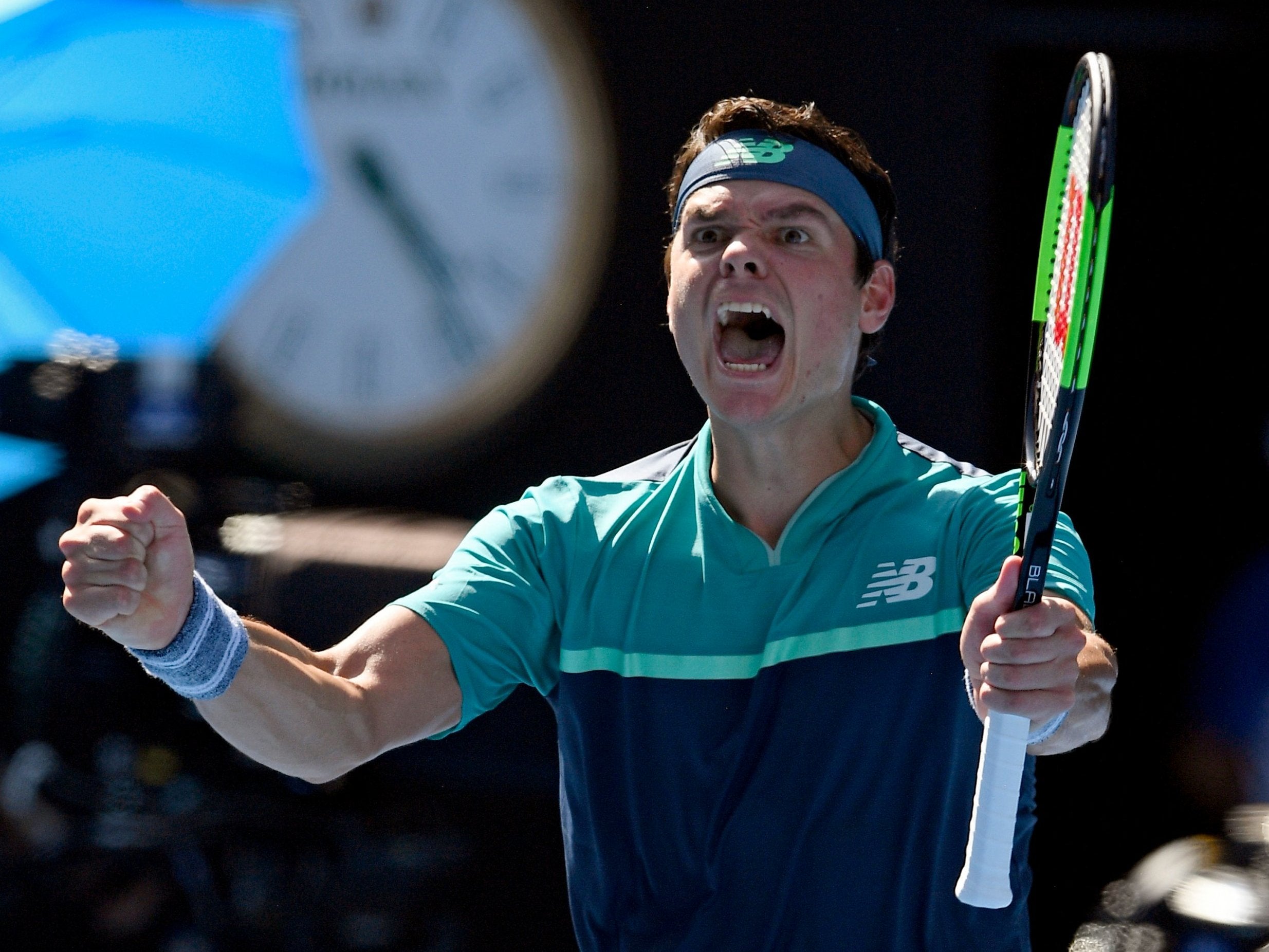 Milos Raonic celebrates defeating Alexander Zverev