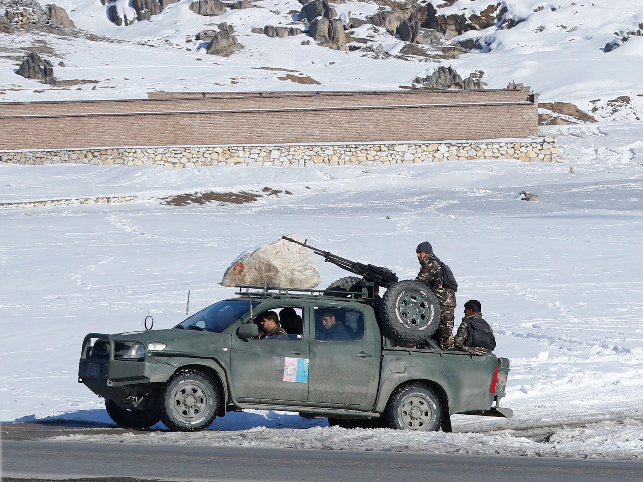 Security forces guarding the damaged military base after the Taliban attack