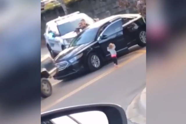 Toddler puts her hands up in front of armed police as father is arrested