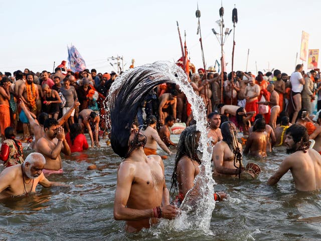 Naga Sadhus, or Hindu holy men, take a dip during the first Shahi Snan (grand bath) at Kumbh Mela