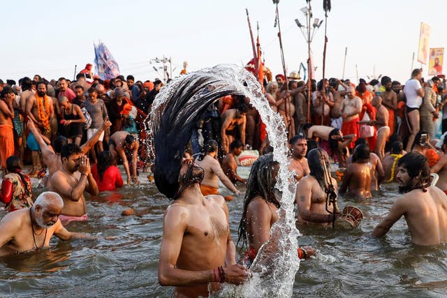 Naga Sadhus, or Hindu holy men, take a dip during the first Shahi Snan (grand bath) at Kumbh Mela
