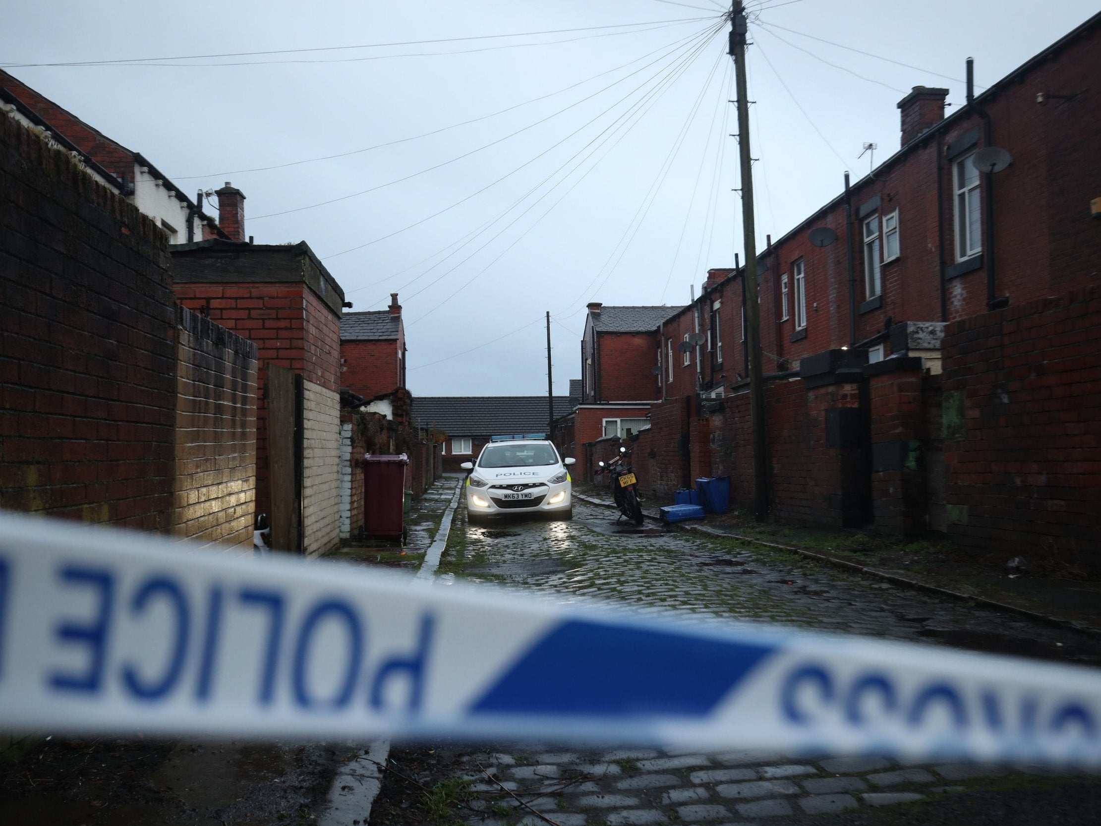 Police at a house in Arthur Street, Little Lever, Bolton, where they are investigating the death of a woman and two young children
