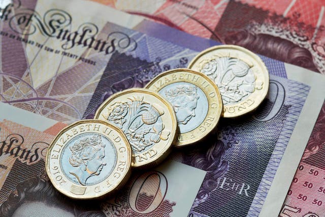 British (GBP) pound coins resting on 50 pound, 20 pound and 10 pound notes