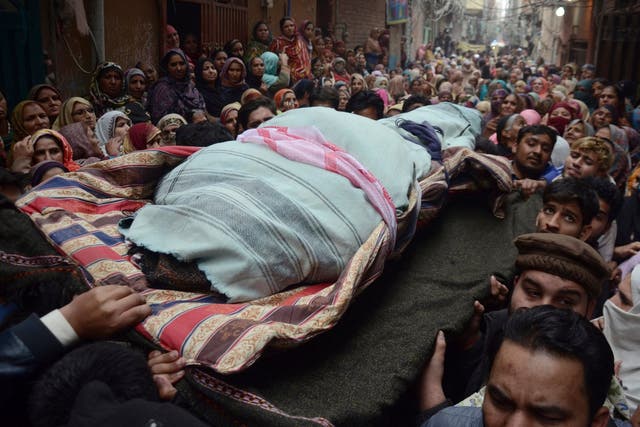 People carry a body of one of the members of a family, who were killed by counter-terrorism officers