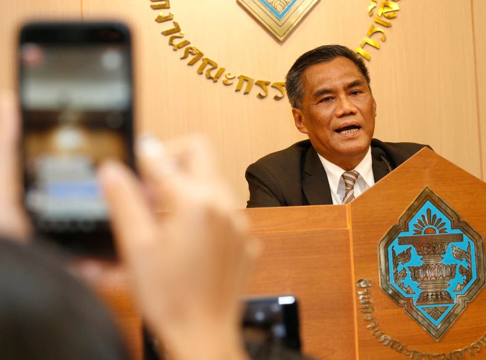 Thai Election Commission chairman Ittiporn Boonprakong (R) speaks to the media during a press conference at the Election Commission Office in Bangkok