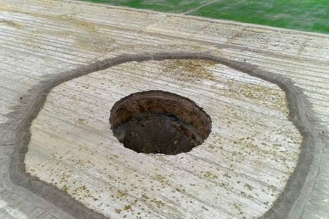 This frame grab from an 8 August 2018 video provided by Iranian Students' News Agency, ISNA, shows an aerial view of a massive hole caused by drought and excessive water pumping