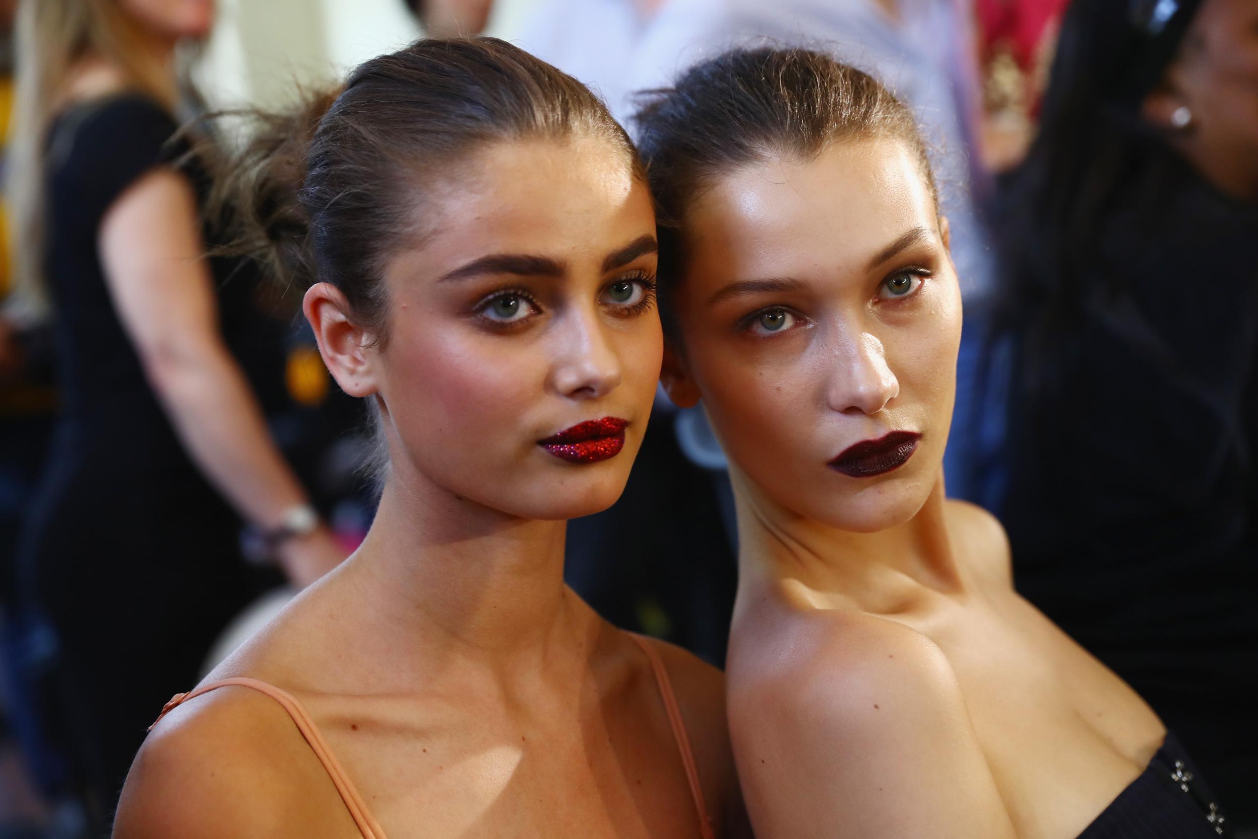 Taylor Hill and Bella Hadid prepare backstage prior to the Atelier Versace Haute Couture AW17