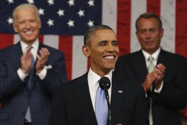 Vice President Joe Biden (L) and Speaker of the House John Boehner applaud as President Barack Obama finishes his State of the Union speech on Capitol Hill in Washington, 28 January 2014.