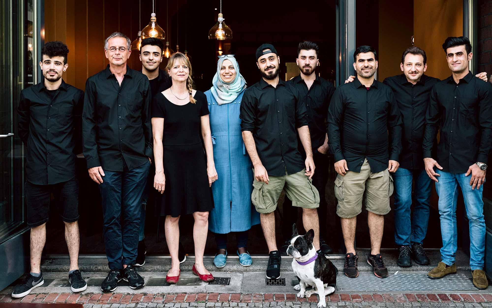 Andreas Tölke, second from left, with asylum seekers that have worked at Kreuzberger Himmel