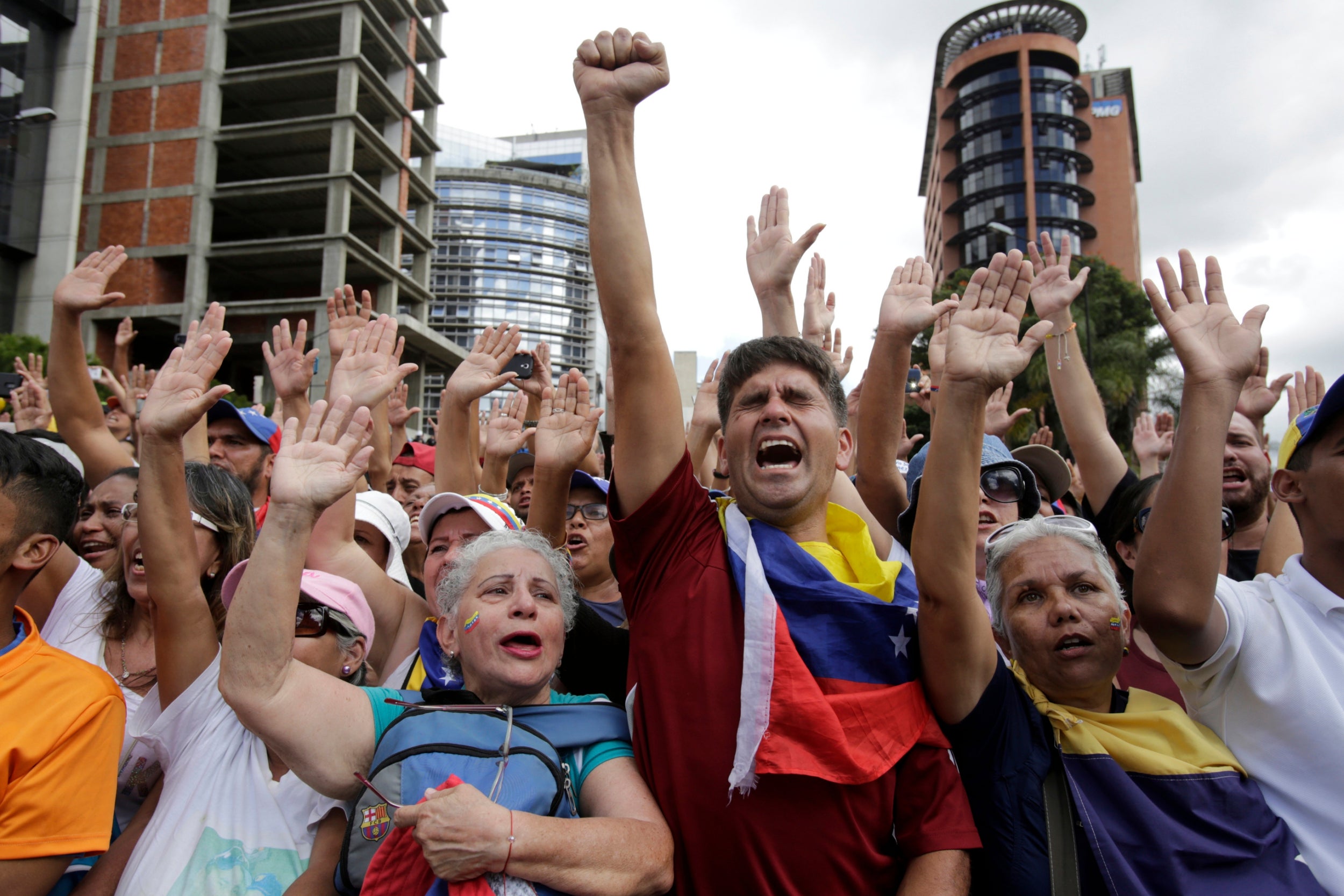 Anti-government protesters cheer after Juan Guaido, head of Venezuela’s opposition-run congress, declared himself interim president