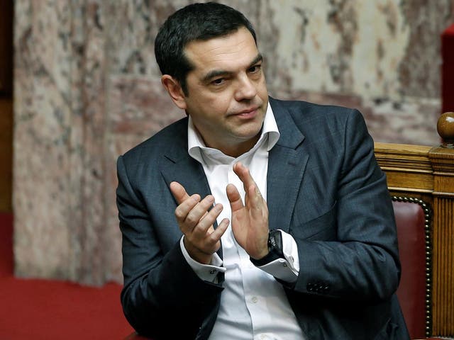 Greek Prime Minister Alexis Tsipras applauds during a parliament session before a vote on an accord between Greece and Macedonia