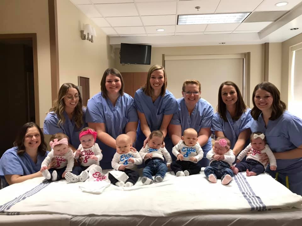 The mothers pose for a photograph with their babies at Anderson Hospital's Pavilion for Women
