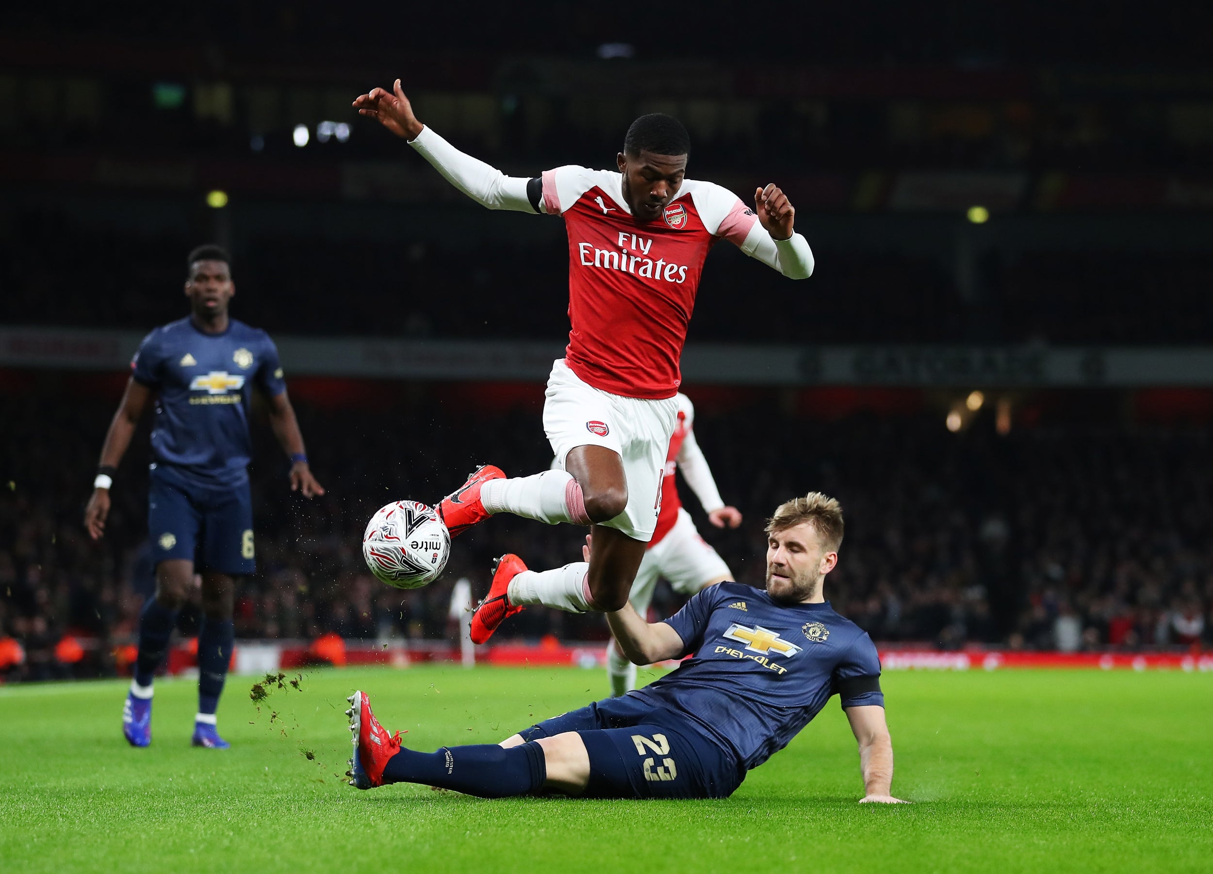 Luke Shaw puts in a sliding tackle on Ainsley Maitland-Niles