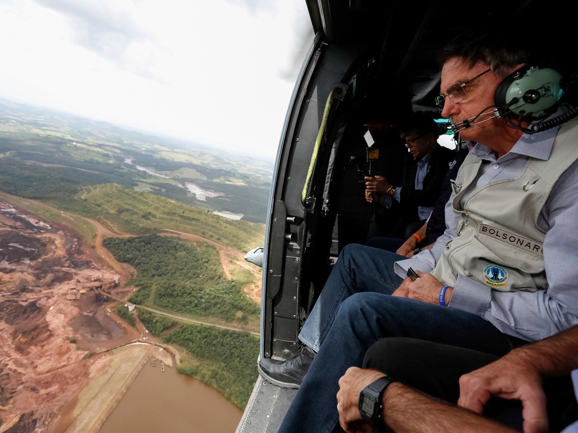 President Jair Bolsonaro surveys area buried by mud in Brumadinho