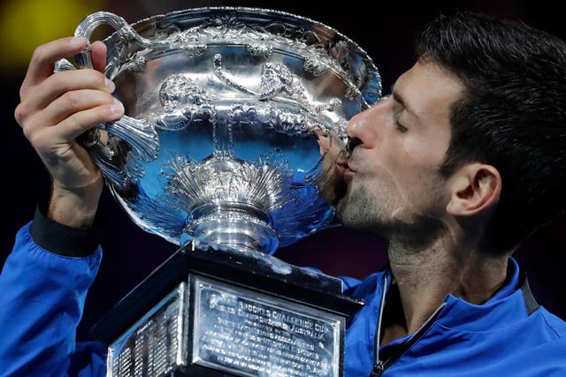 Novak Djokovic of Serbia holds his winners trophy after defeating Rafael Nadal of Spain in their men's singles final match at the Australian Open Grand Slam tennis tournament in Melbourne, Australia,