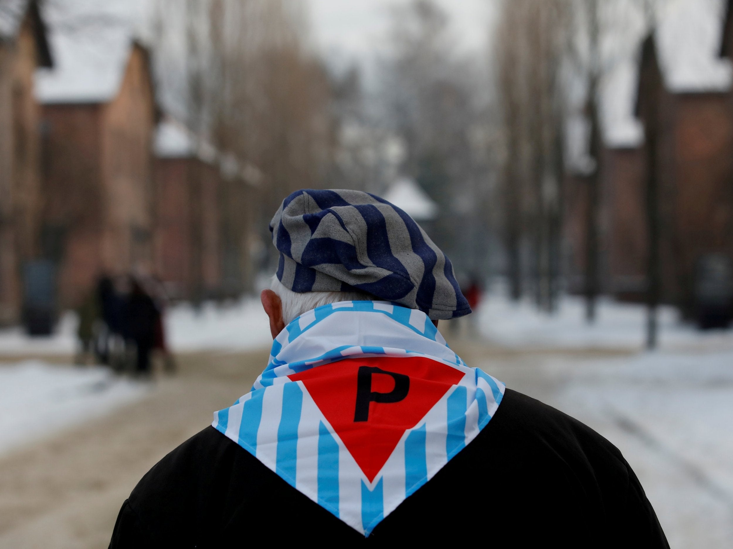 A survivor attends a ceremony marking the 74th anniversary of the liberation of the camp in January