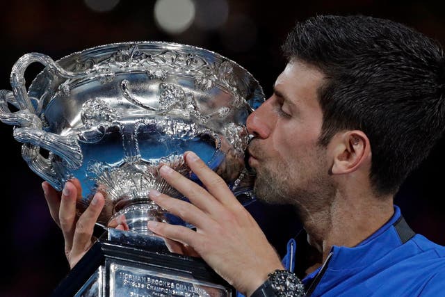 Serbia's Novak Djokovic kisses his trophy after defeating Spain's Rafael Nadal