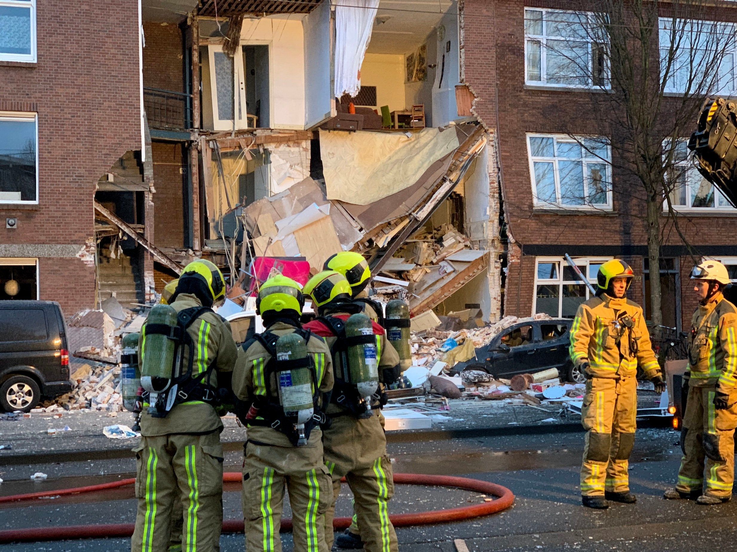 Emergency workers recovered two injured people from a collapsed three-story home