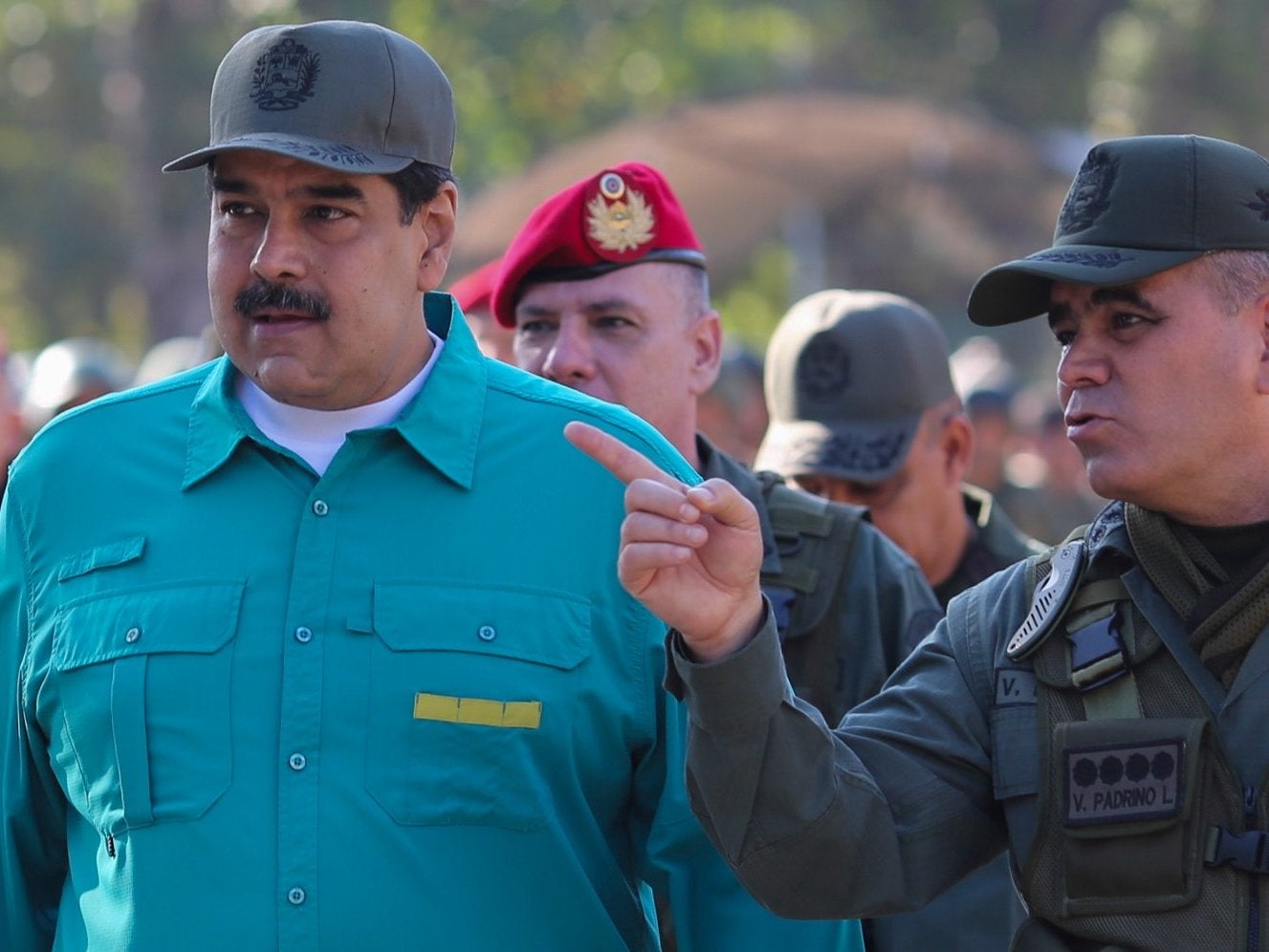 Venezuela's President Nicolas Maduro (L) listens to Defence Minister Vladimir Padrino during military exercises on January 27, 2019