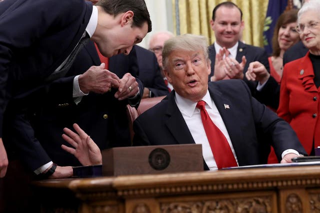 Pictured: Senior adviser to the President Jared Kushner (L) leans in to speak with US President Donald Trump during the signing ceremony for the First Step Act and the Juvenile Justice Reform Act in the Oval Office of the White House 21 December 2018 in Washington, DC.