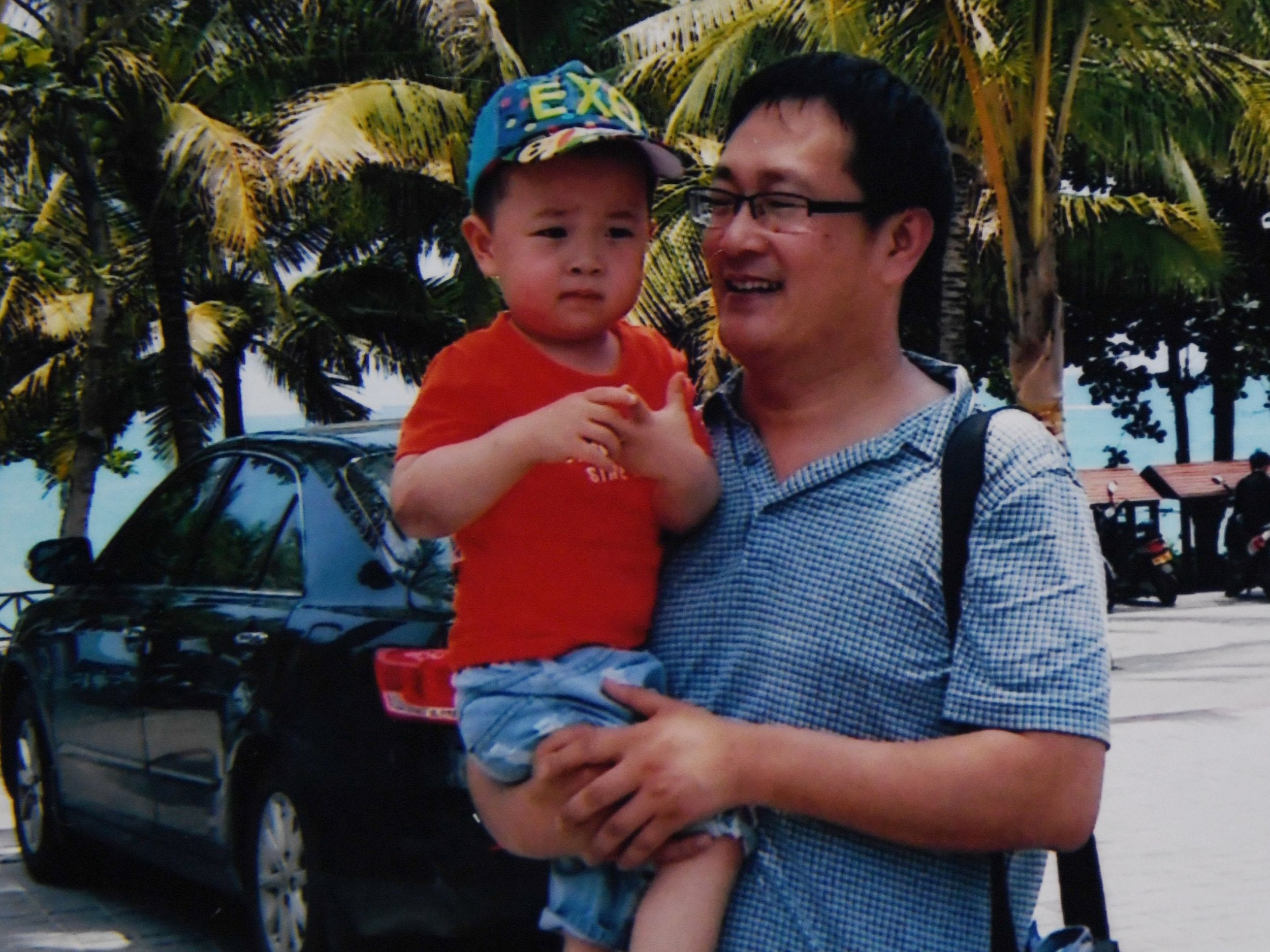 Wang Quanzhang (R) is seen here with his son Wang Guangwei in China's southern Hainan province, not long before he was taken away by the authorities in 2015