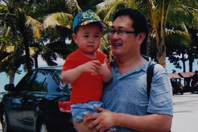 Wang Quanzhang (R) is seen here with his son Wang Guangwei in China's southern Hainan province, not long before he was taken away by the authorities in 2015