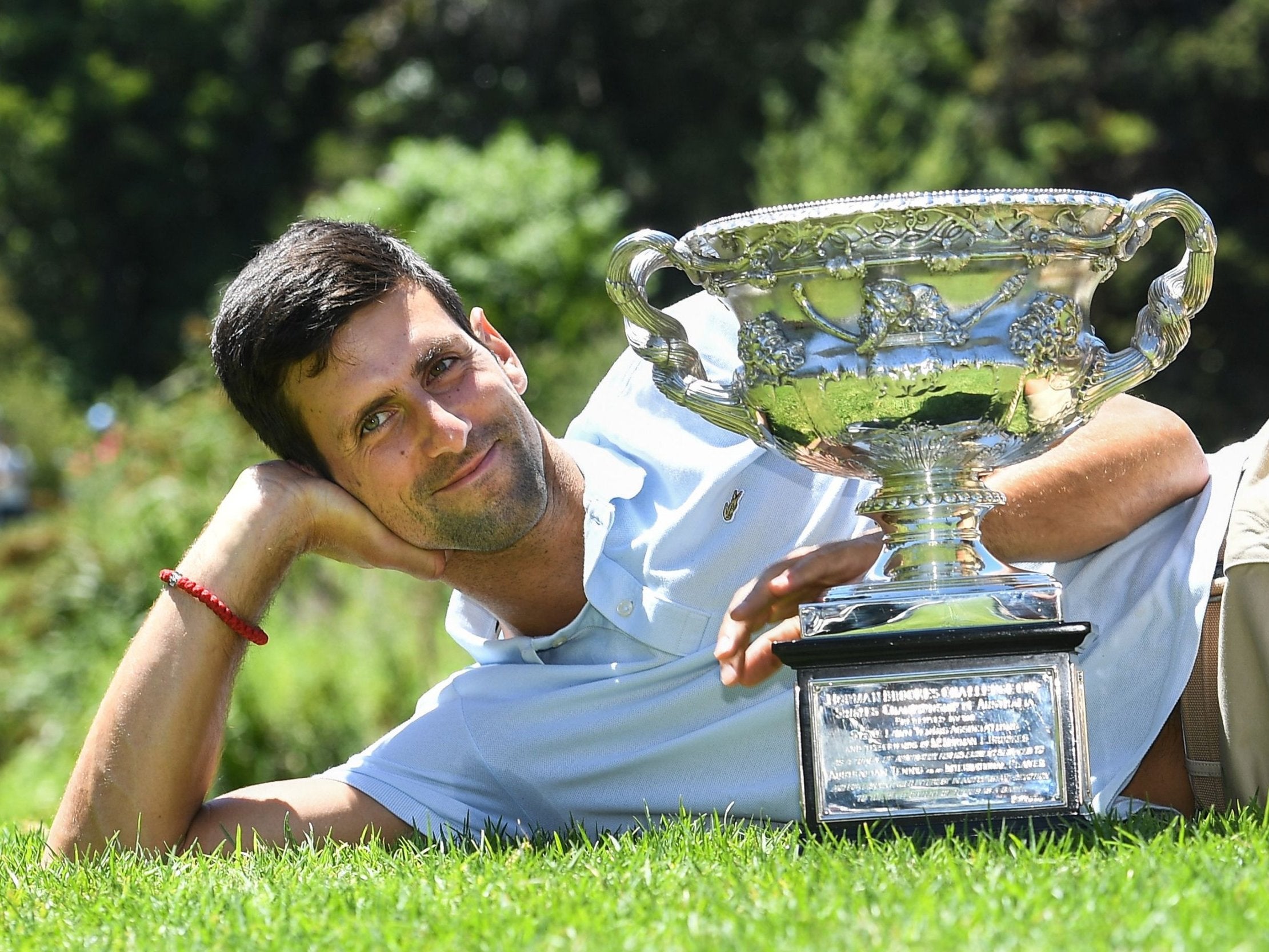Novak Djokovic poses with the Australian Open championship trophy at the Royal Botanical Gardens