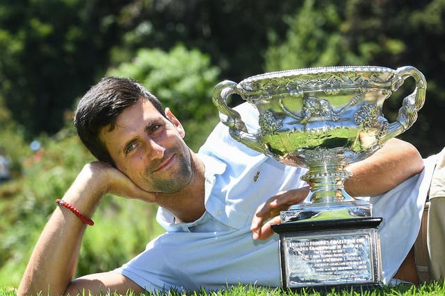 Novak Djokovic poses with the Australian Open championship trophy at the Royal Botanical Gardens