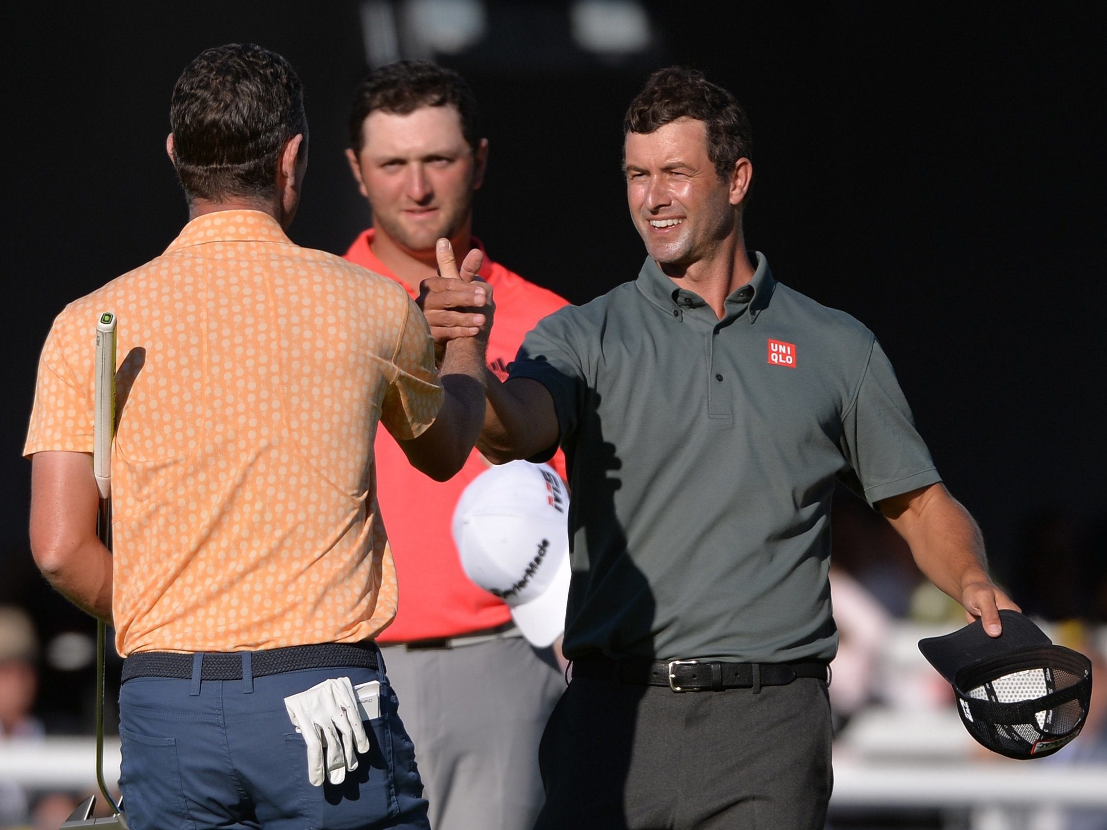 Adam Scott congratulates Justin Rose