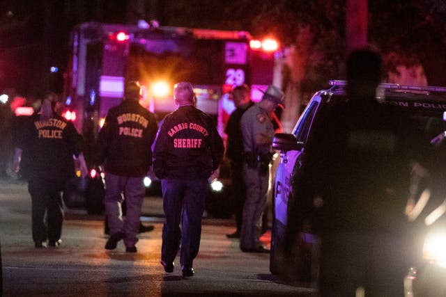 Houston Police officers investigate the scene in Houston where five of their colleagues were shot.